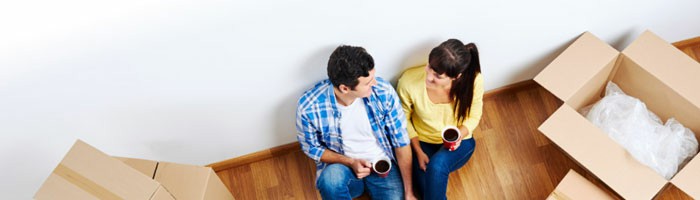 Couple taking a break while unpacking things