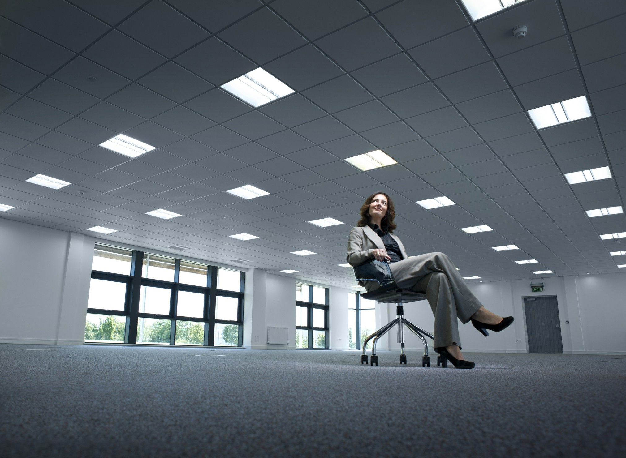 Businesswoman sitting in an empty office space.