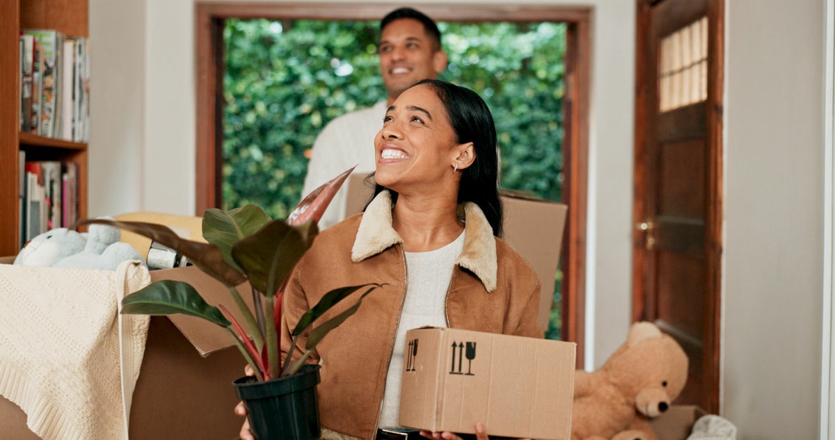7 Essential Things To Do Right After Moving To A New Home A man and woman are carrying boxes into a house, preparing for a move. 7 Essential Things To Do Right After Moving To A New Home