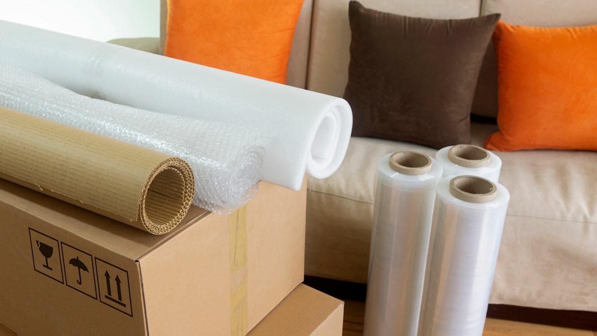 Packing Materials What's Needed For A Smooth Move A couch cluttered with moving boxes and packing supplies, highlighting necessary items for an efficient move; Packing Materials What's Needed For A Smooth Move