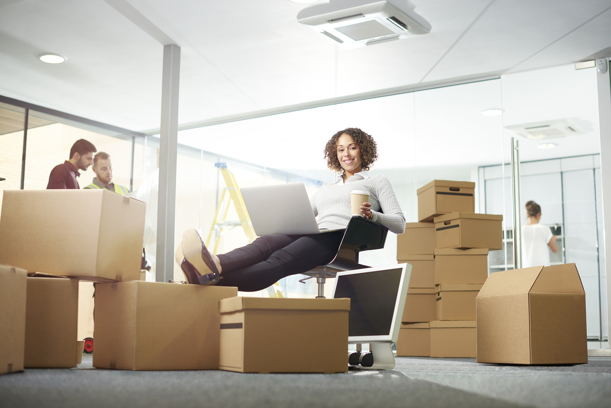 Lady relaxing the the middle of a an easy office move