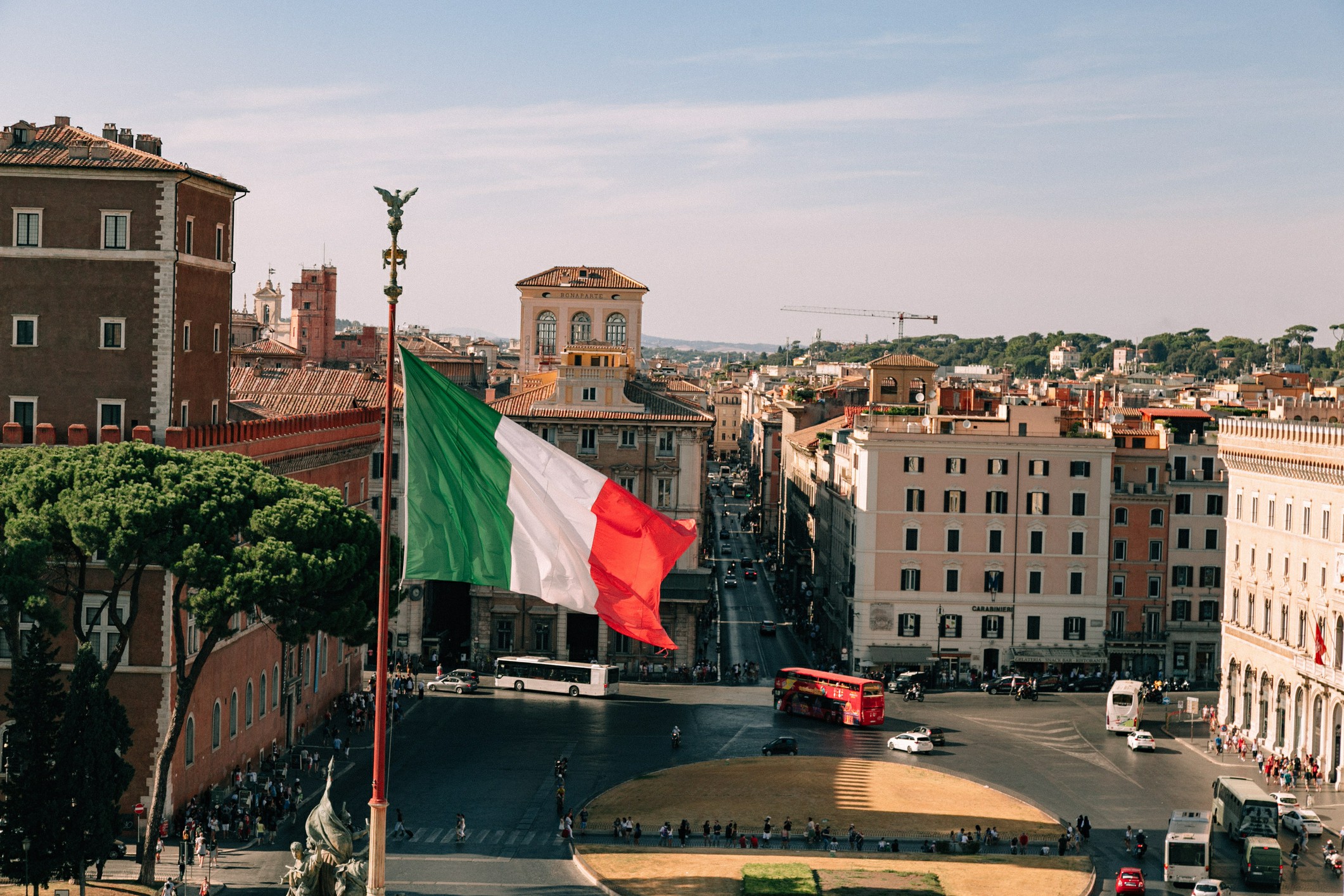 Italian flag waving in iconic Italian square Italian flag waving in iconic Italian square