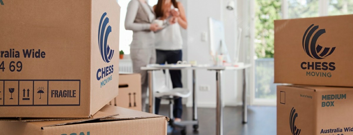 Woman packing moving boxes in her home