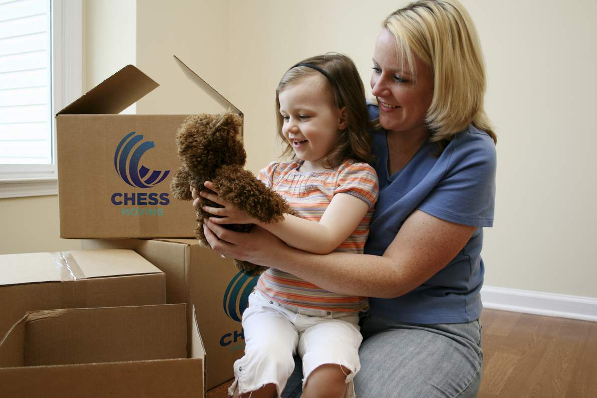 mother and daughter with chess moving boxes, getting ready for packing