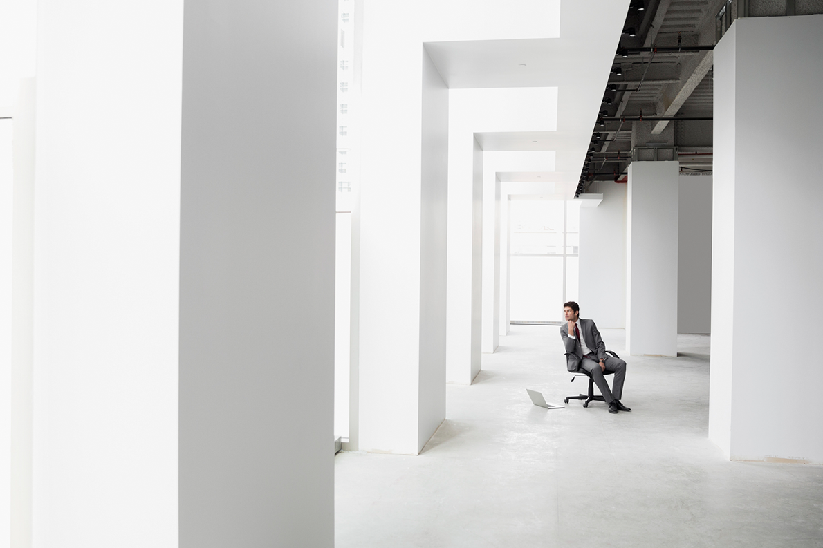 A man sitting in a brand new office building