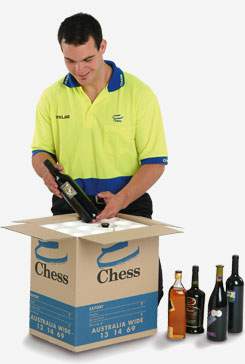 Chess moving staff packing wines into a small box