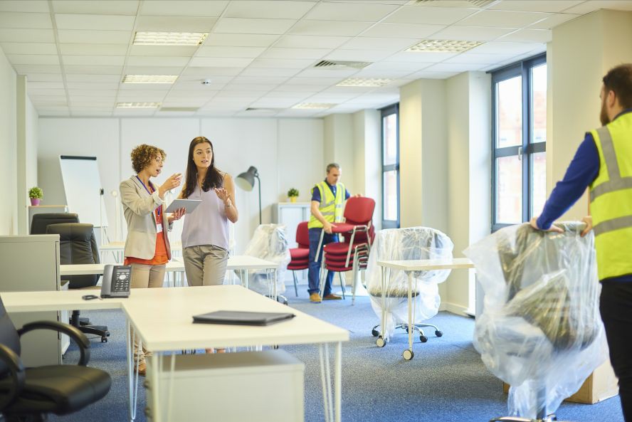 office admin planning on office relocation, movers helping 